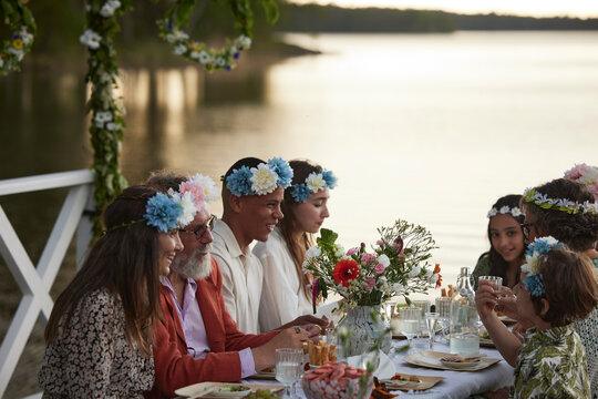 Family having midsummer meal at lake