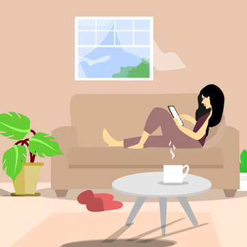 Young woman sitting alone on a couch at home and surfing on internet,shopping online or chatting.
