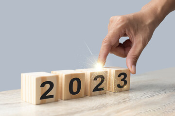 hand stack wood cube block, 2023 year numbers calendar stacked with copy space for start new...