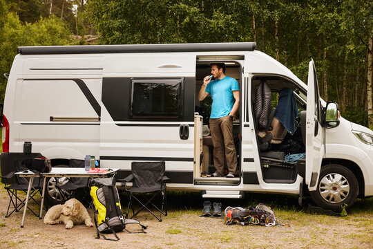 Man camping with dog in camper van