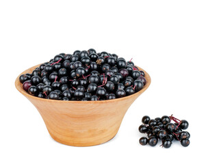 Elderberry in a wooden cup isolated on a white background