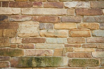 Background texture of a stone wall photo. Natural stone wall texture for the background. Old brick texture, grunge background of a brick wall.
