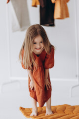 A beautiful 4-year-old girl runs and has fun, jumps and laughs emotionally