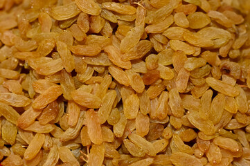 Golden Dried Seedless Grapes Top View. Raisins Background.