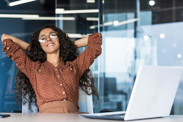 Young woman engineer developer programmer works in the office inside the IT company, satisfied with...