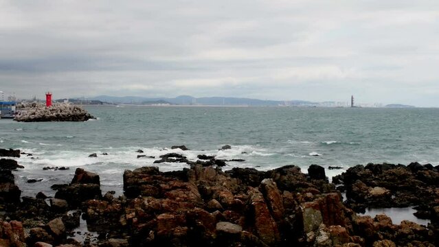 Seascape of waves crashing onto rocky shore