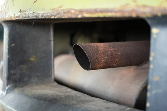 An old exhaust pipe of the truck or forklift vehicle. Transportation equipment object photo, selective focus at metal surface part.
