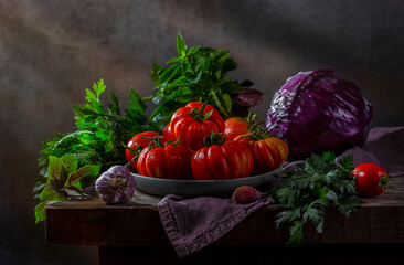 Fresh vegetables on a rustic table against a dark background