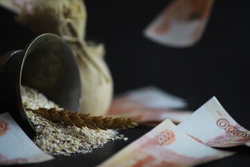 The concept of the cost of grain. 5000 ruble banknotes around a handful of ground grain. World...