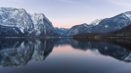 Beautiful alpine lake reflecting surrounding peaks during sunrise, wide shot, Austria, Europe