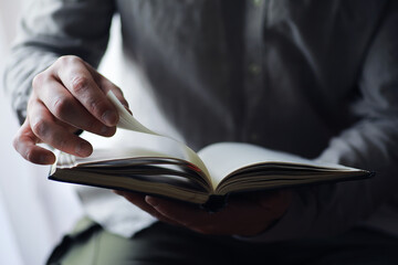 Read book. A man sits and reads literature. Textbooks to study. Religion.