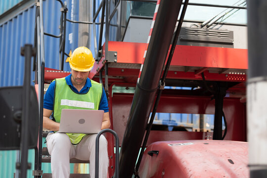 Young man working with computer at logistic import and export terminal industry.