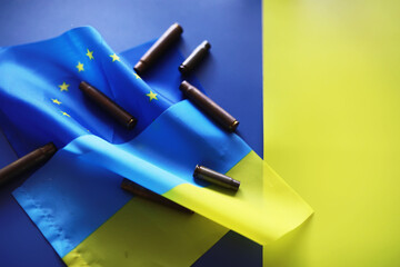 The concept of European Union support for Ukraine in a military conflict. Solidarity. Politics. Flags are on the table.