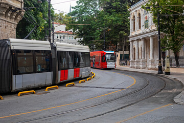 Naklejka na ściany i meble modern street two trams go to meet each other. travel, horizontal.