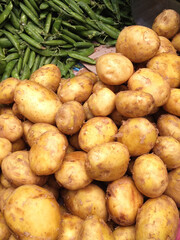 Potatoes and green beans in boxes on the market.
