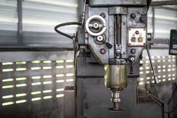 Heavy steel milling head and control panel of the lathe machinery. Industrial equipment object, close-up and selective focus.