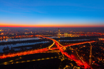 Fototapeta premium Vienna evening panorama . Illuminated Vienna city and Danube river . Urban infrastructure aerial night view 