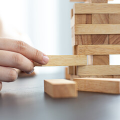 Planning to reduce investment risks, plan and strategy in business, Establishing a business risk mitigation plan to create stability for the company, Business growth with wooden blocks concept.