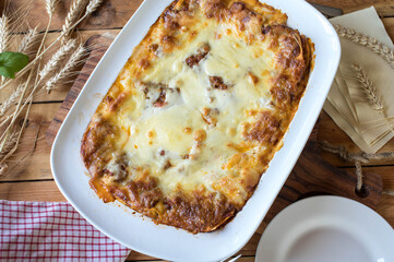 Lasagne bolognese, bechamel sauce and mozzarella cheese topping in a casserole dish