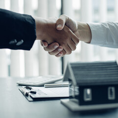 Property manager Shake hands with congratulations on the customers who bought the house with...