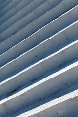 White concrete stairs with blue shadows, abstract photo