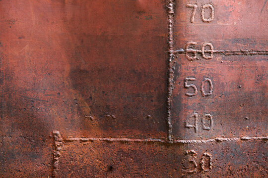 Grungy old ship hull with weld seams and draft marks