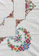 Embroidered table cloth close up photo. Beautiful flower pattern detailed photo. Stitch embroidery design. 