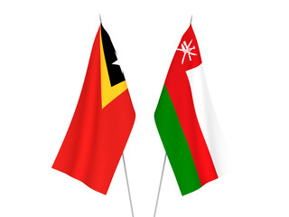 National fabric flags of East Timor and Sultanate of Oman isolated on white background. 3d rendering illustration.