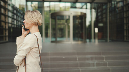 Close up, businesswoman talking on the cellphone on business center background