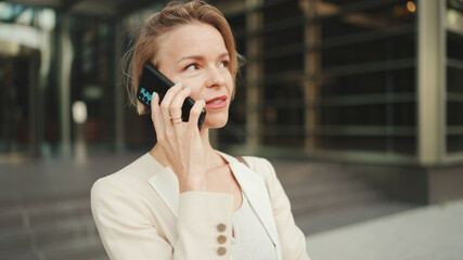 Close up, businesswoman talking on the cellphone on business center background