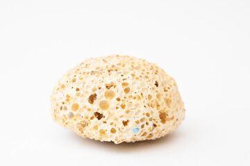 Round porous pumice stone on a white background