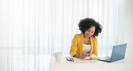 Black African smiling beautiful business woman working in office use computer with copy space....