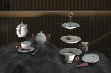 Symbolic art exhibition featuring human facial organs on tea sets. Selective Focus.