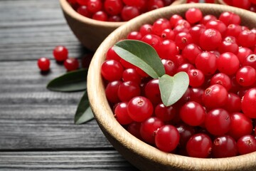 Ripe fresh cranberry on grey wooden table, closeup