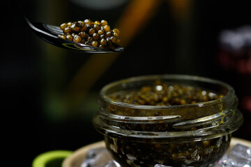 Black caviar on a black background, a beautiful background. Russian cuisine.