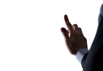A cutout of a businessman's arm reaching out as if to press a button on a touchscreen device in a low light room. A design element for use with composite imagery