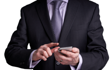 A cutout of a businessman holding and operating a touch screen phone. A design element for use with composite image creation.