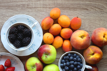 Various healthy seasonal food arranged on wooden background. Flat lay.