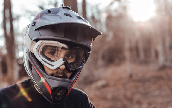 Man in helmet and sport glasses in forest