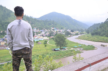 a man looking the nature on the top of the city.