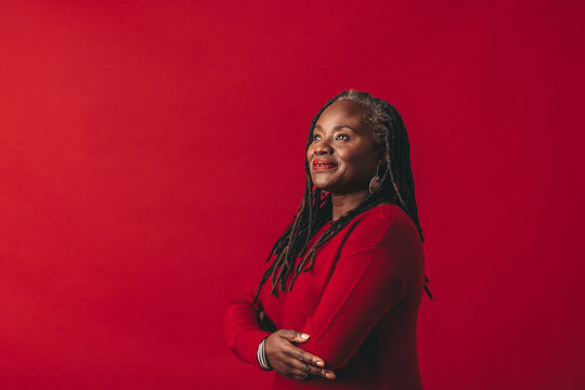 Pensive Woman With Dreadlocks Standing In A Studio