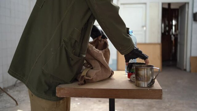 stalker is going on a journey in a destroyed post-apocalyptic building. collects things in a backpack. Doomsday and armageddon survivor concept