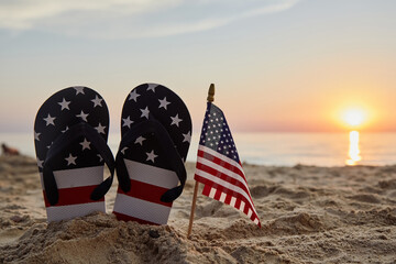 Labor Day USA background with with flip flops on the sandy beach. Patriotic USA background