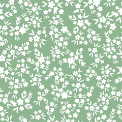 Simple vintage pattern. small white flowers and leaves. light green background. Fashionable print for textiles and wallpaper.