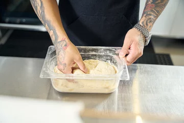 Foto op Canvas Pizza master getting the frozen dough ready for braking © Svitlana