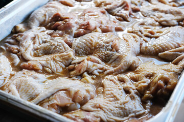 Raw marinated chicken breasts with spices. Top view, closup marinated raw grilled chicken in  sauce.