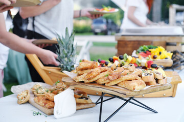Self service food buffet. Guests at a relaxed party outdoor