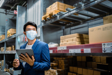 Portrait of a confident Asian worker in a large warehouse. Wholesale, logistics, business, export. The manager inspects the goods at the warehouse. In the distribution center.