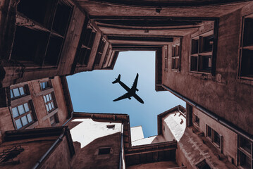 A plane passes over an old building in the old city of Lyon