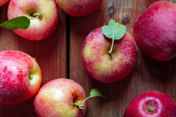 freshly picked red apples on rustic wooden table